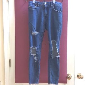 Distressed blue jeans with pockets.